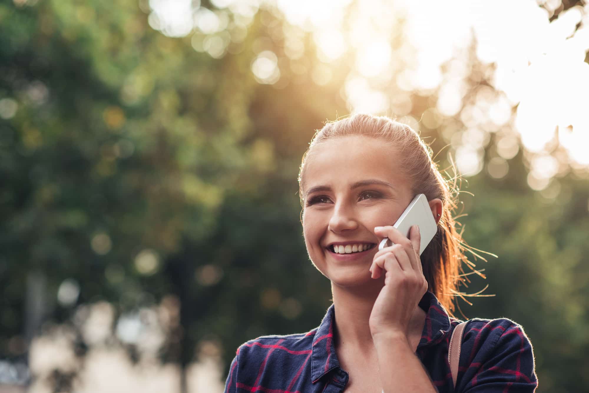 A woman on the phone dealing with sales and acquisitions of commercial machinery